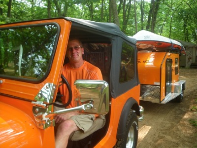 Orange color jeep and trailer and Legend sea kayak, nigel foster image