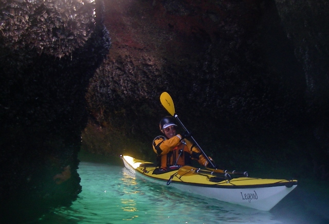 Nimble Legend sea kayak negotiates sea cave, kayak by Nigel Foster