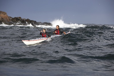 Surfing swells in DoubleShot tandem kayak by Nigel Foster