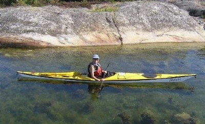 Kristin Nelson paddles Nigel Foster Silhouette sea kayak