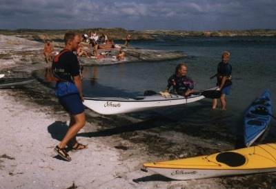 Two men carry a Silhouette with kayaker